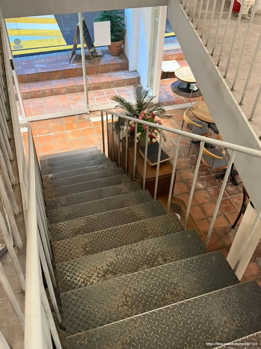 Café seating beside the first-floor stairs