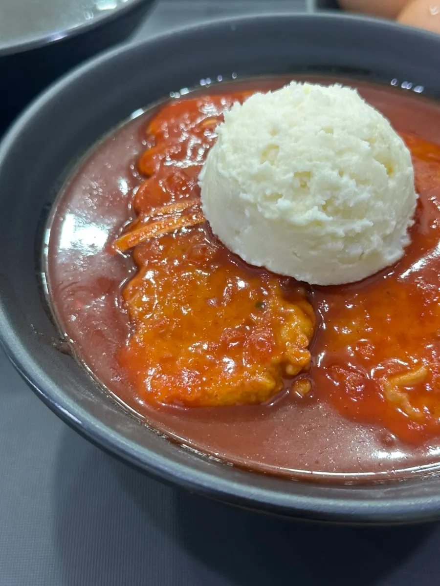 Thick sauce clinging to a piece of garaetteok