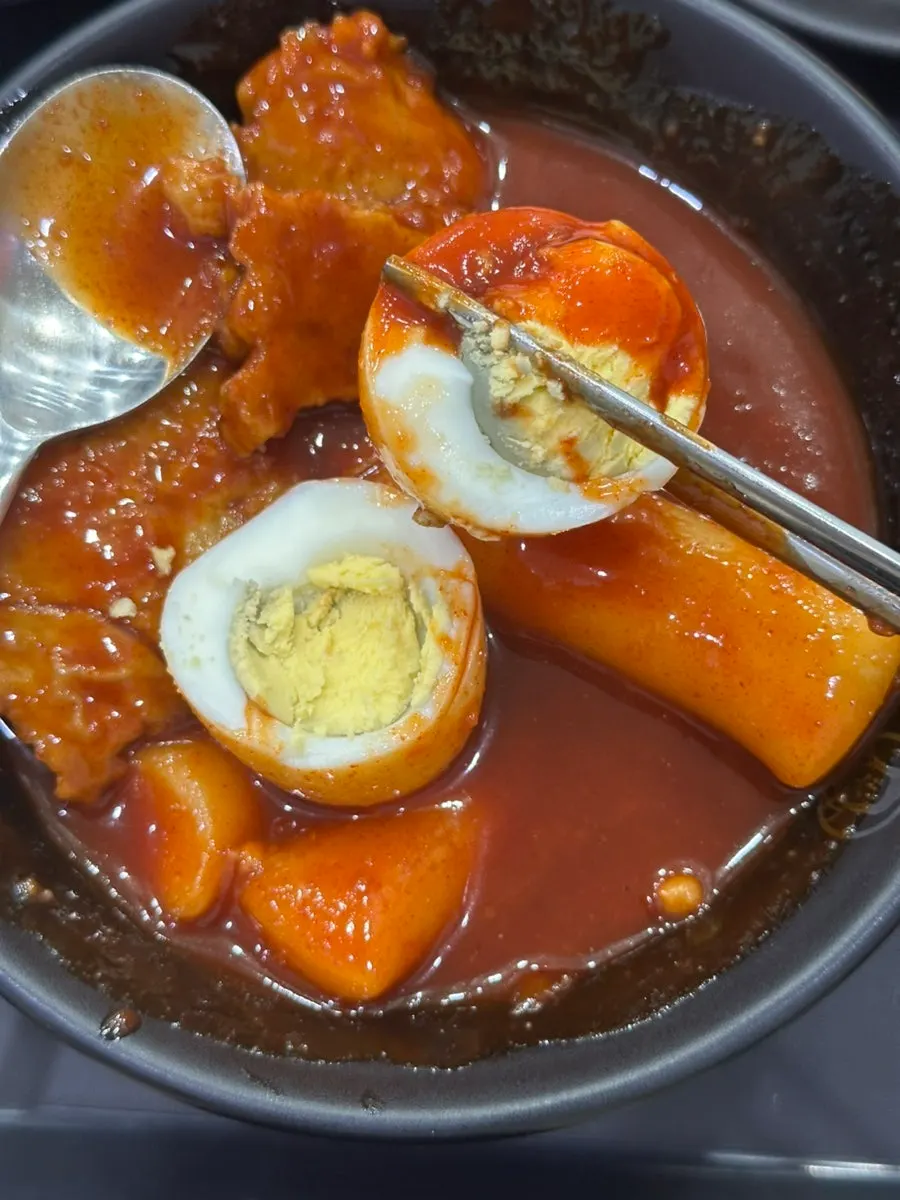 A cup of fish cake broth served with the meal