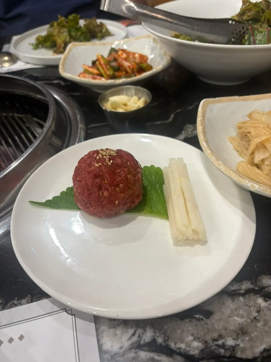Hanwoo beef grilled over charcoal by a staff member