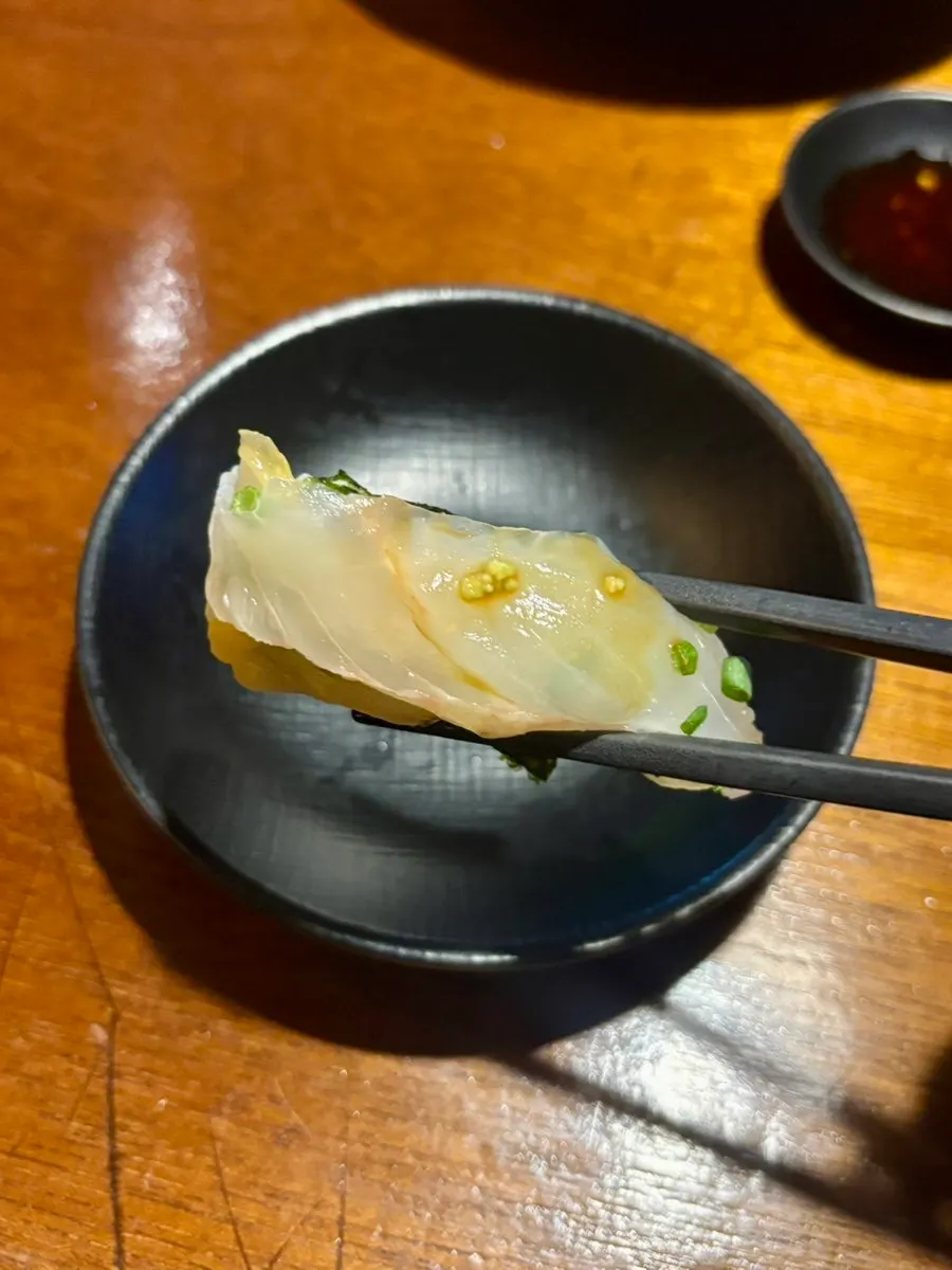 Close-up of gimbap topped with flounder and aged kimchi