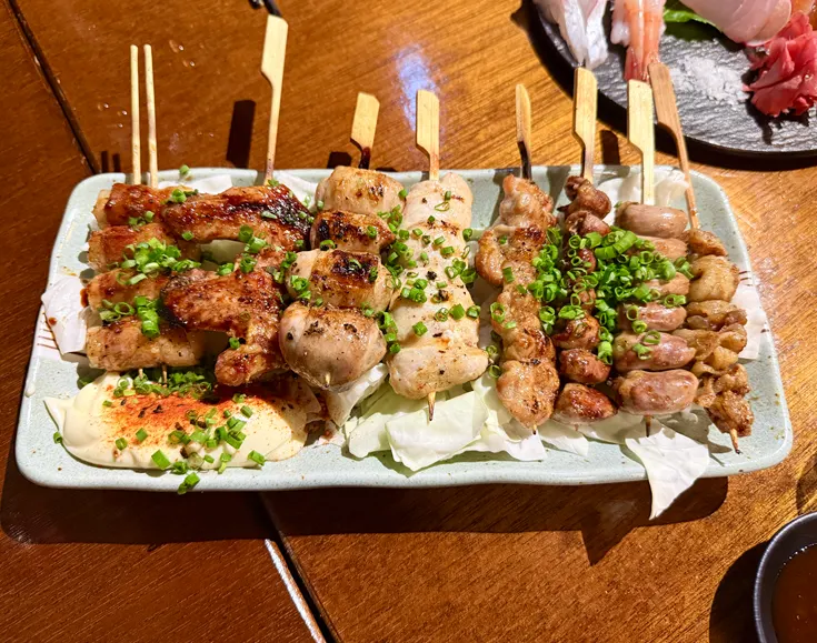 Yakitori skewer laid over cabbage