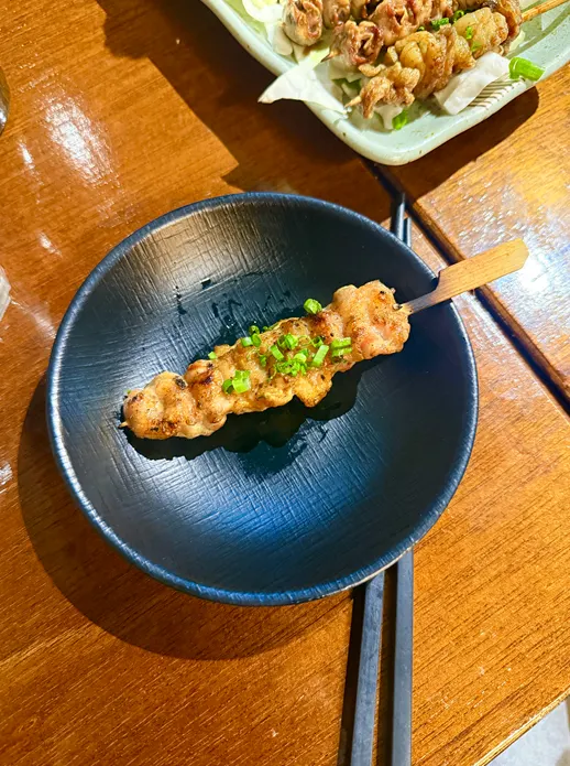 Close-up of pork belly rice cake roll skewer