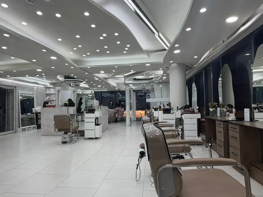 Hair salon interior with bright floor-to-ceiling windows