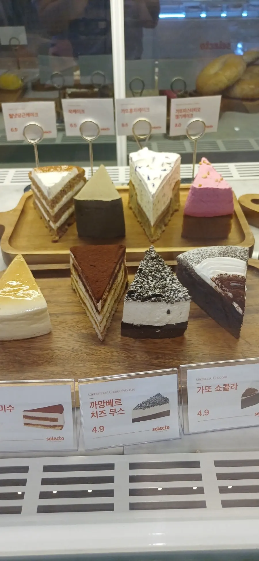 Cheesecake and tiramisu in the dessert case