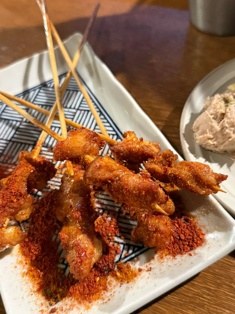 Yangkkochi-style chicken cartilage skewers dusted with shichimi seasoning