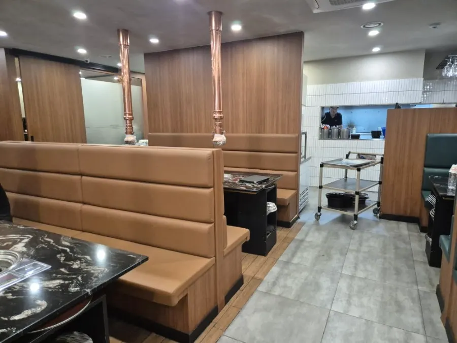Hall seating separated by high sofas at Deo Bareun Jeongyuk Sikdang
