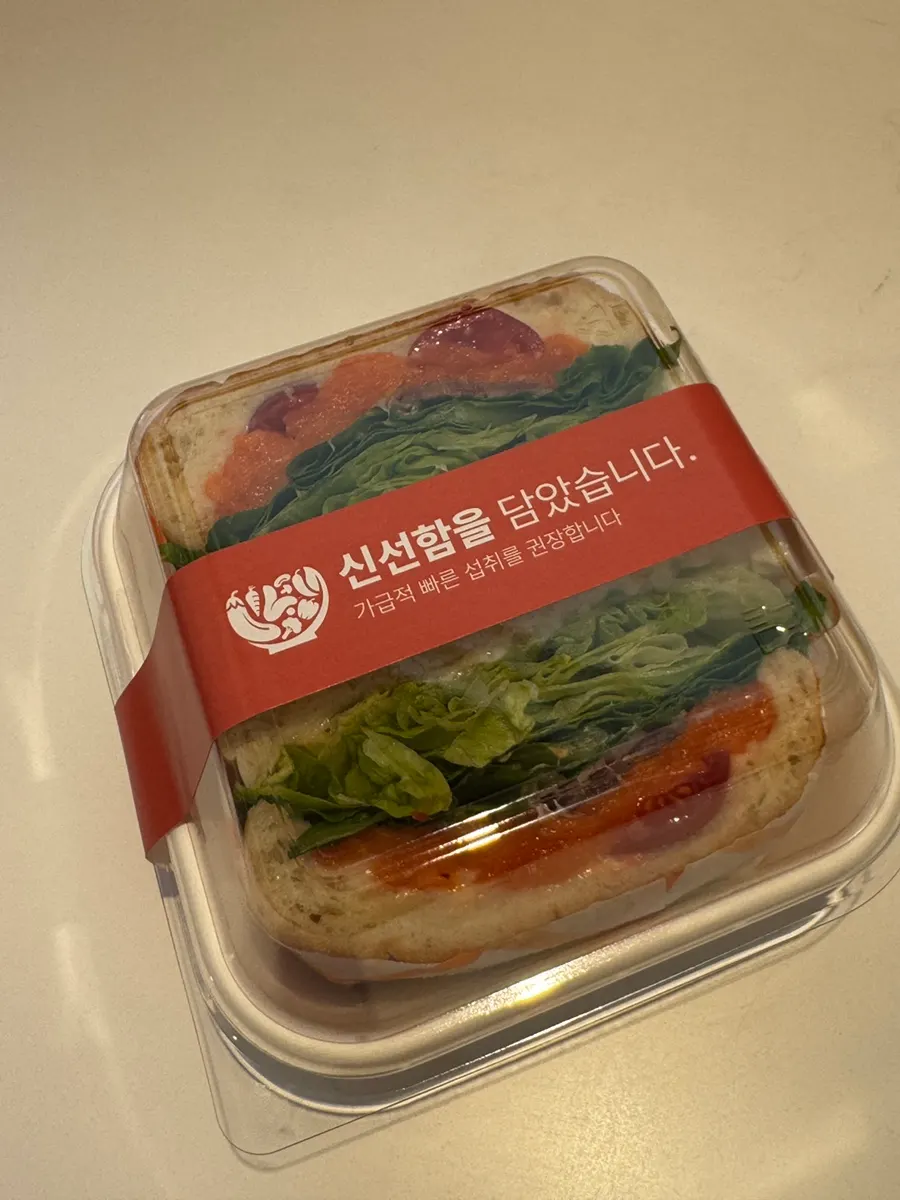 Sandwich and americano set on a booth seat table