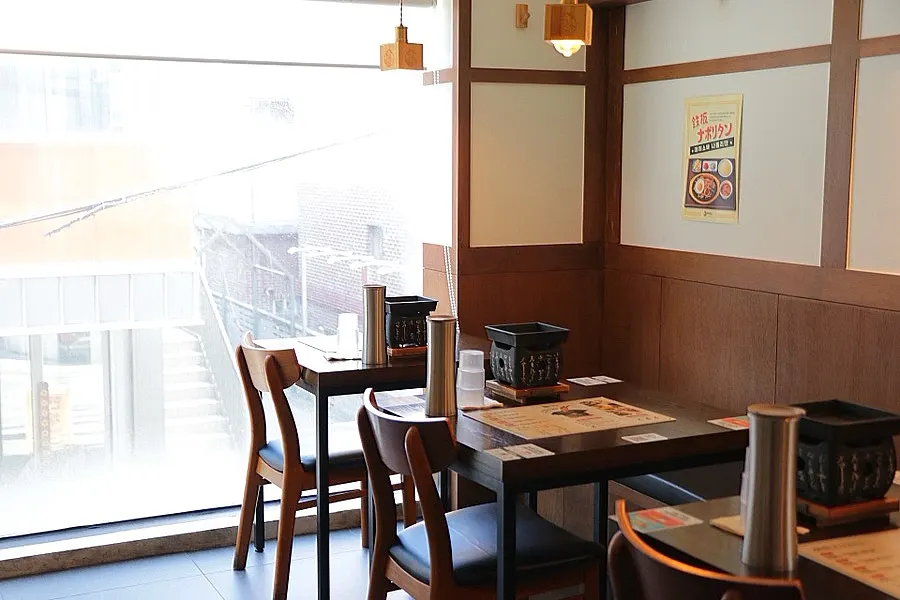Restaurant interior with wood tones and soft lighting