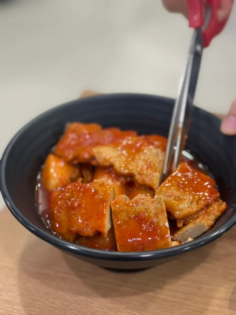 Close-up of garaetteok tteokbokki in red sauce