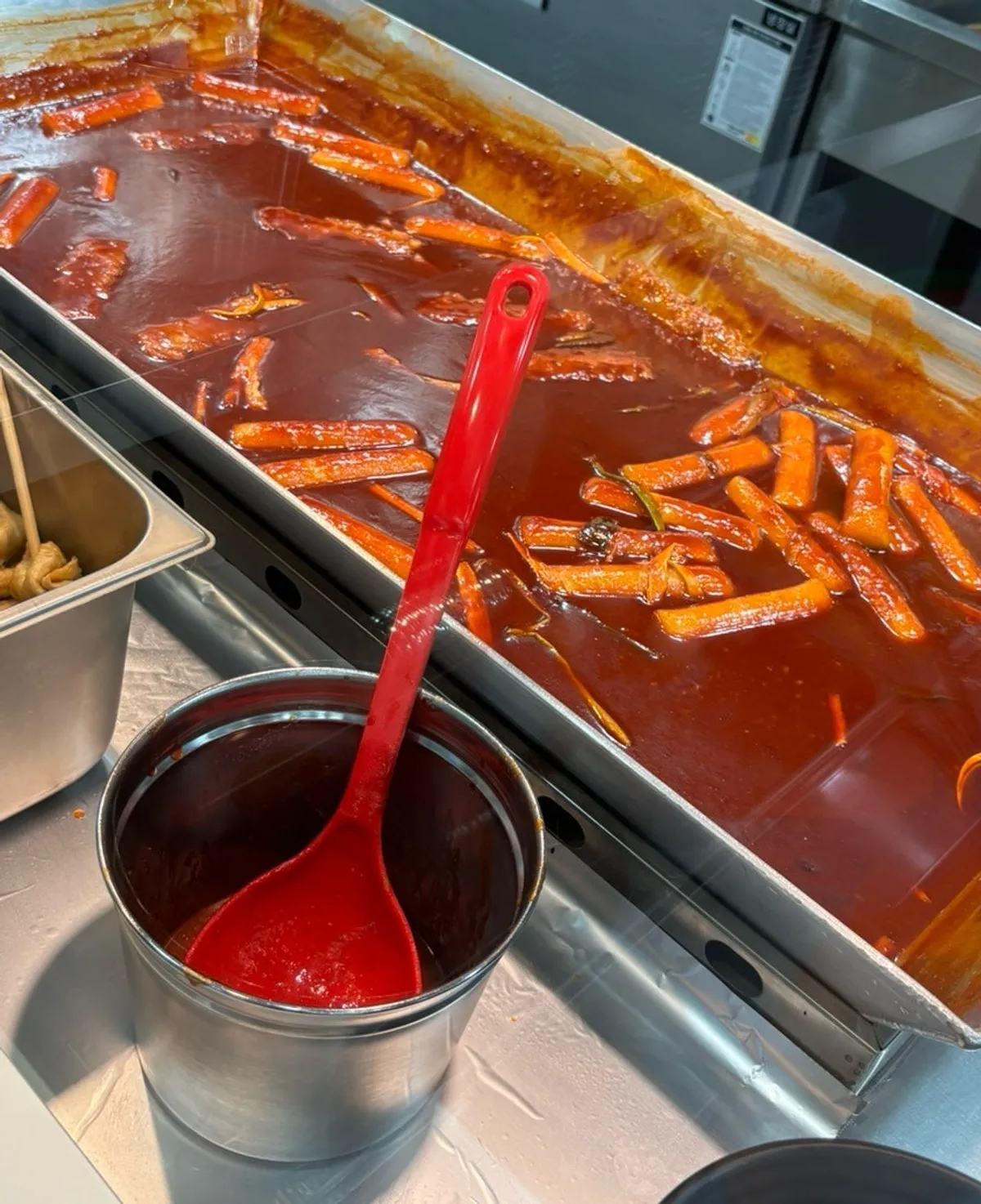 Rice garaetteok simmering in gochujang sauce