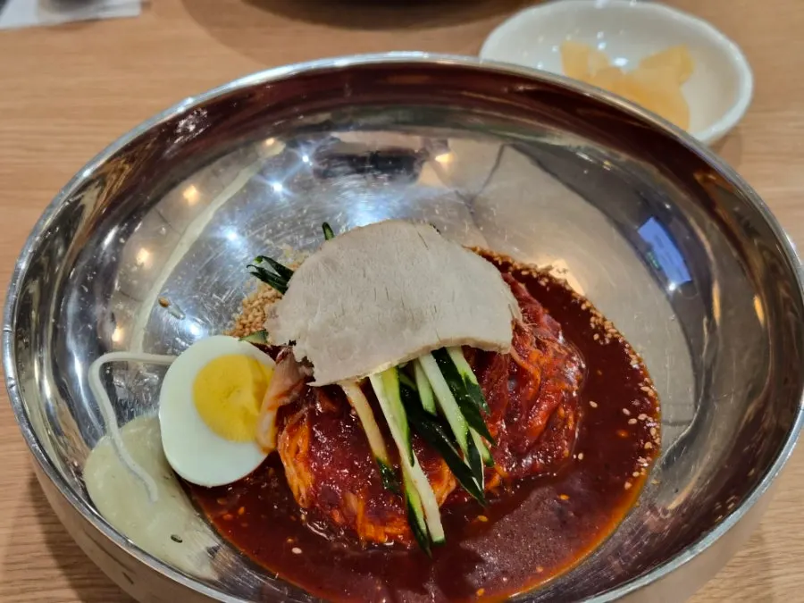 Bright red bibim milmyeon mixed with sauce