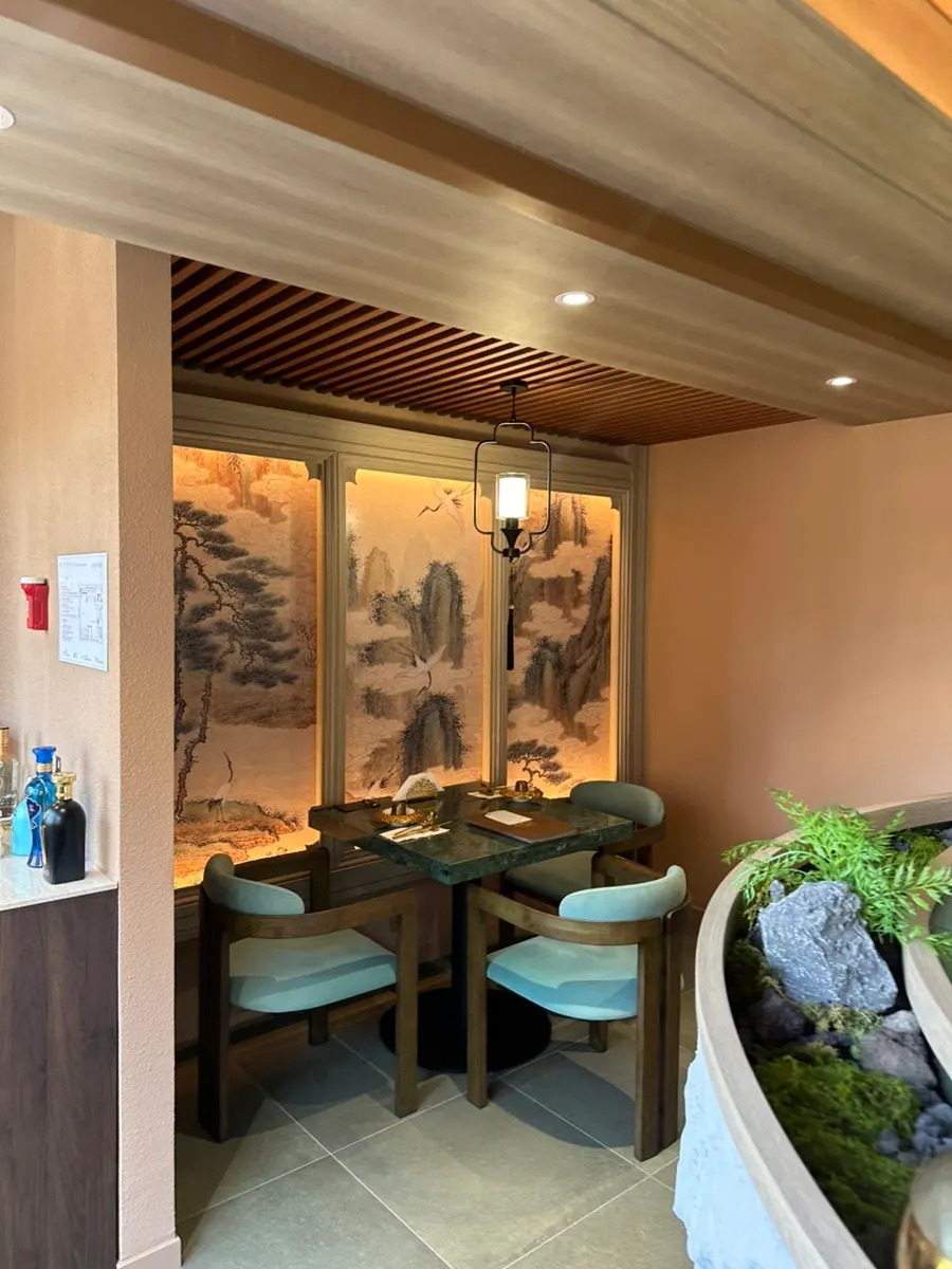 Interior of Samsin in wood tones with green accents