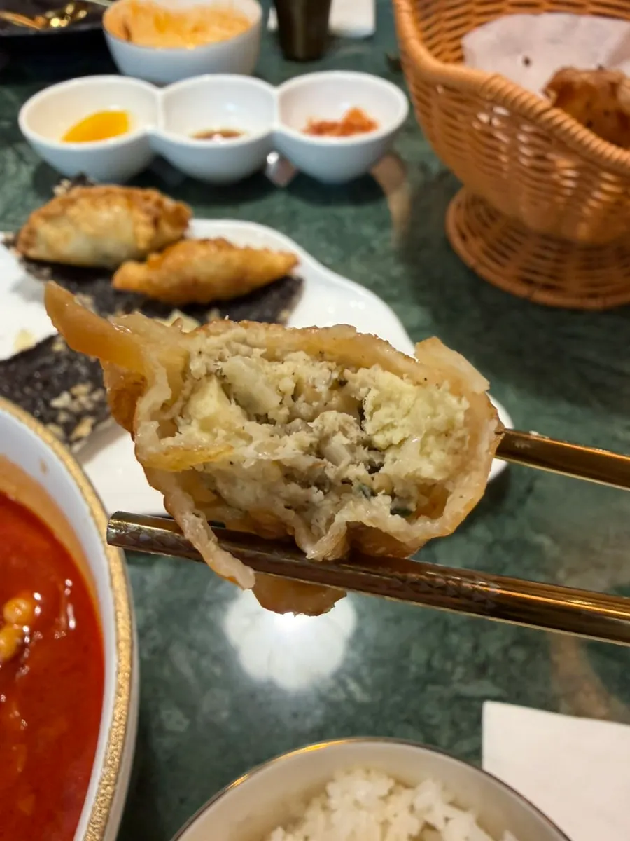 Fried dumpling dipped in chili oil sauce