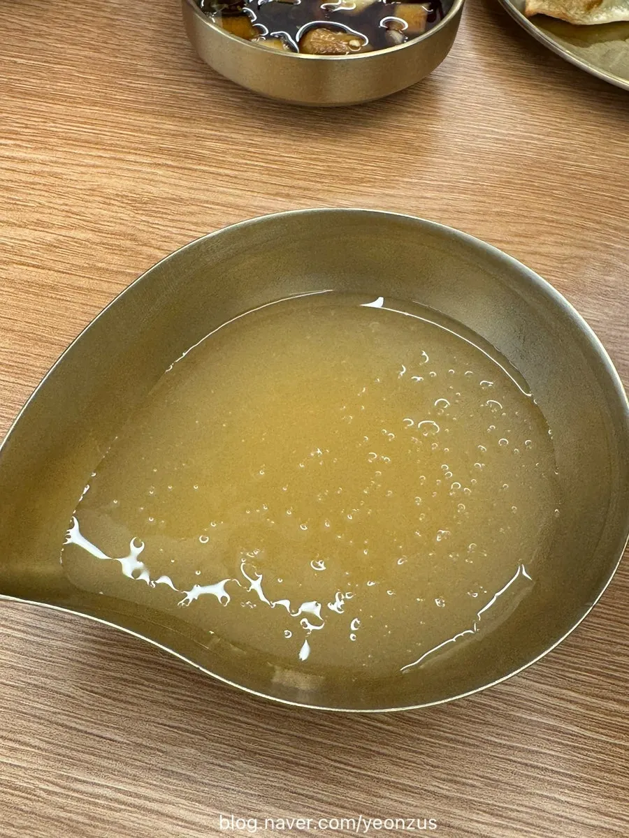 Broth served alongside the bibim makguksu