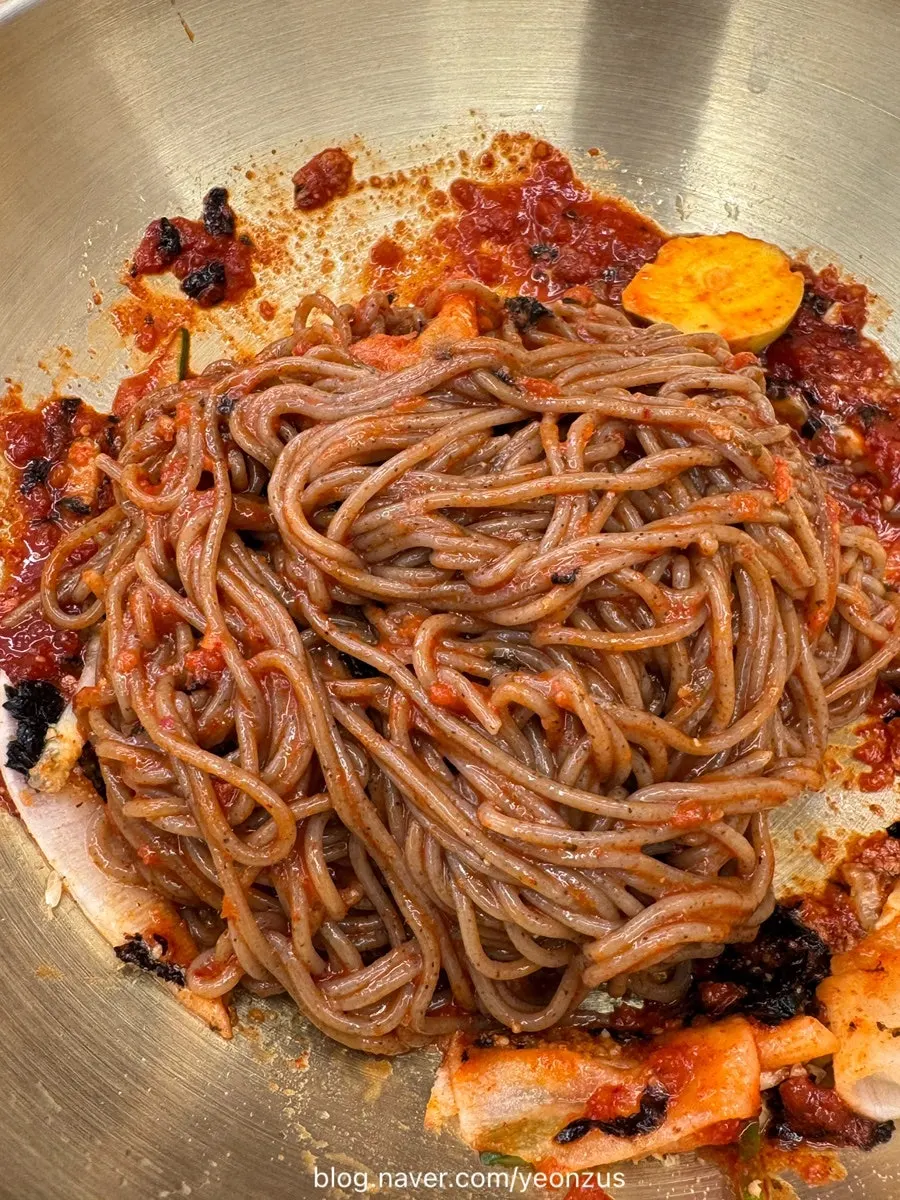 Noodles evenly coated with sauce in the bibim makguksu