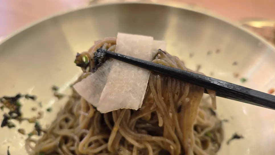 Noodles lifted with chopsticks