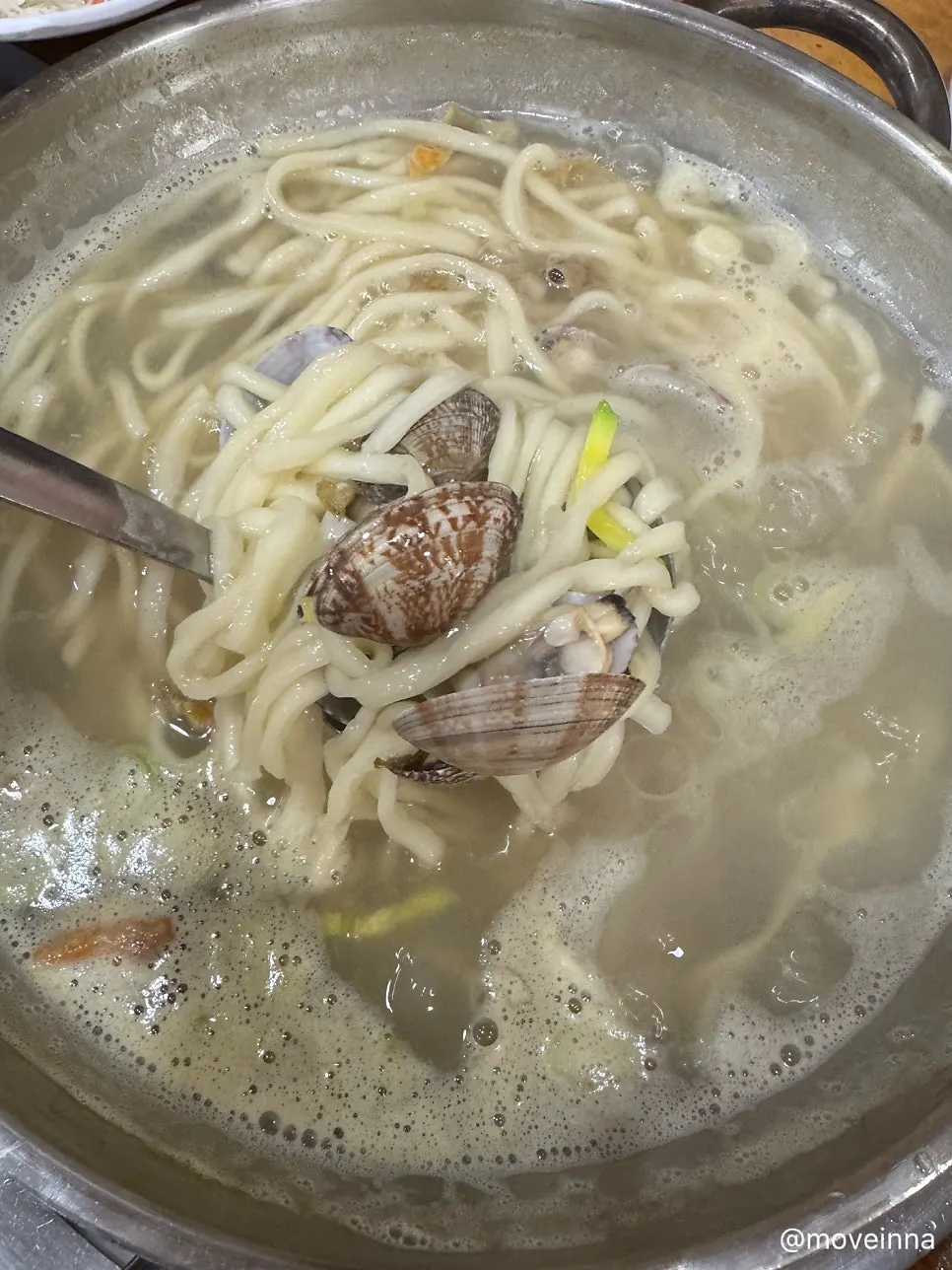 Finished clam kalguksu with noodles added to the boiling broth