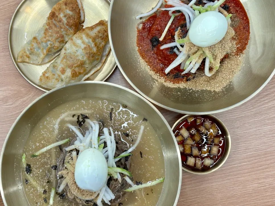 Table spread of makguksu and mandu for a family dinner