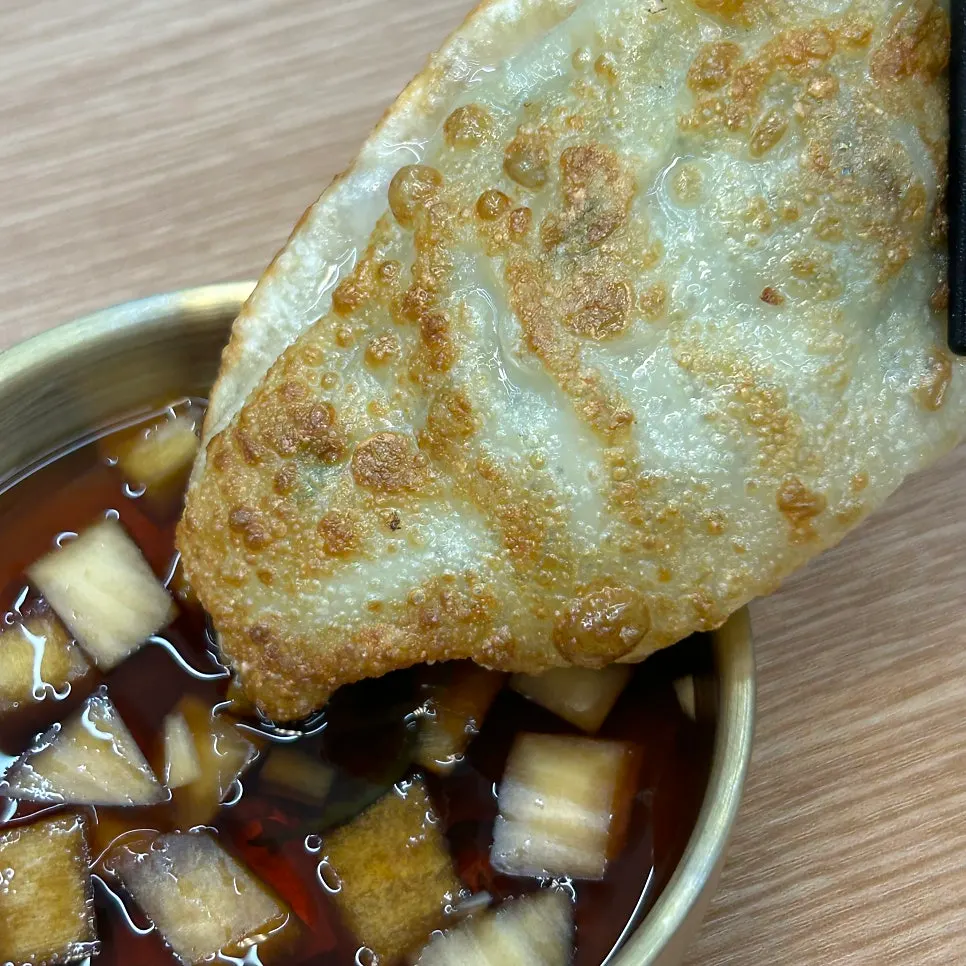 Cross-section of a mandu with a crispy exterior