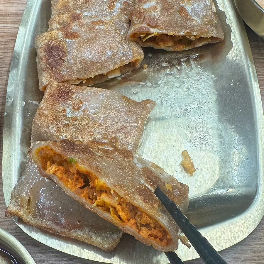 Inside of the buckwheat pancake filled with kimchi
