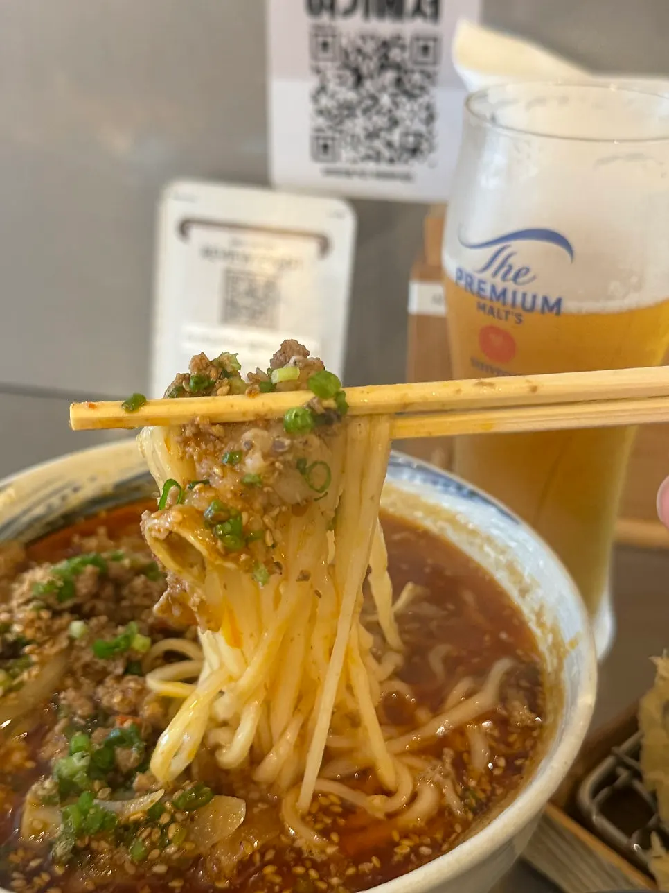 Vertical photo introducing udon with mala flavor