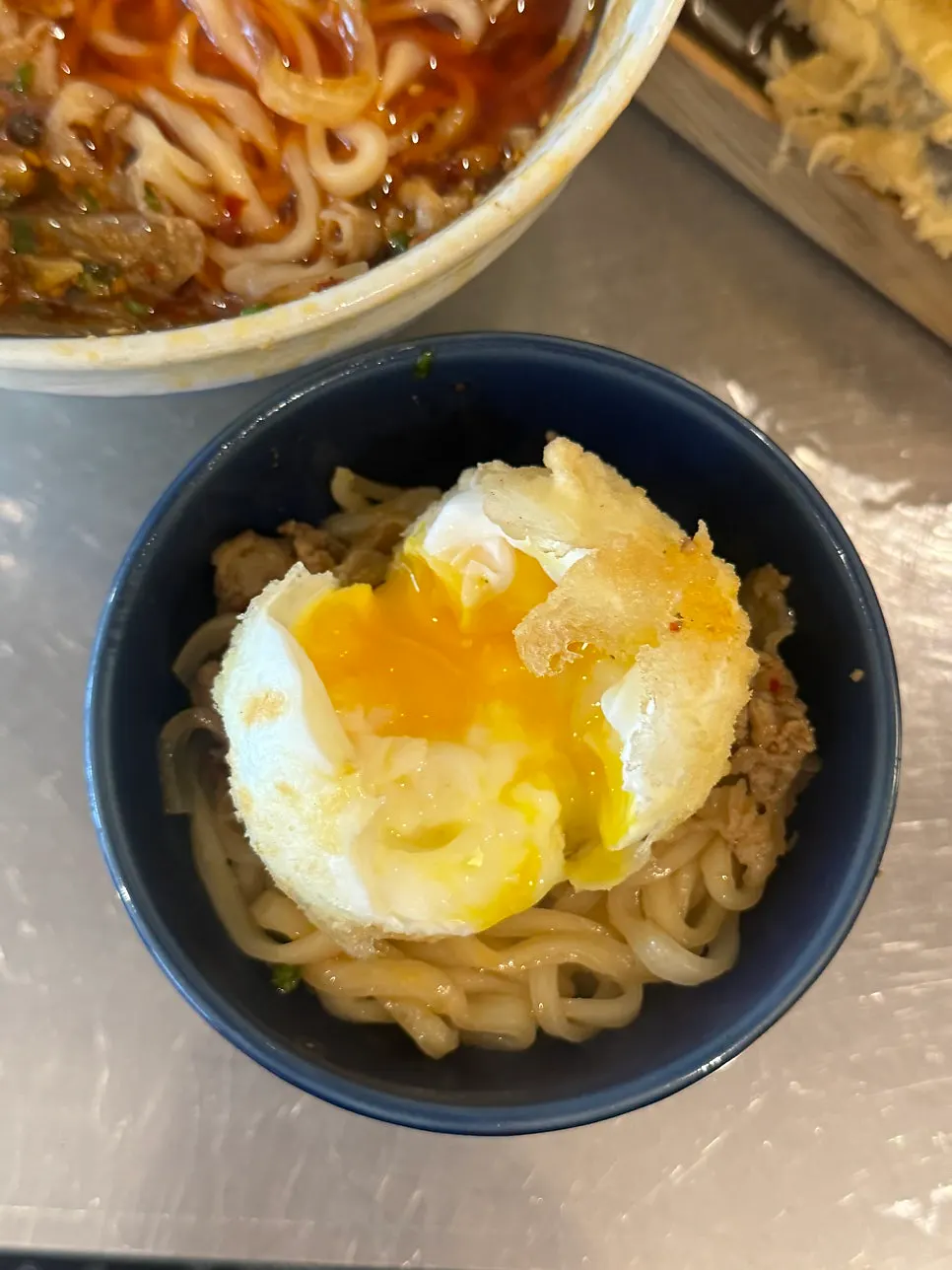 Vertical photo introducing udon with tempura and draft beer