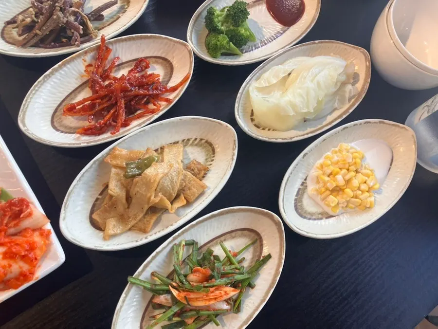 Modest portions of side dishes including seasoned bracken fern