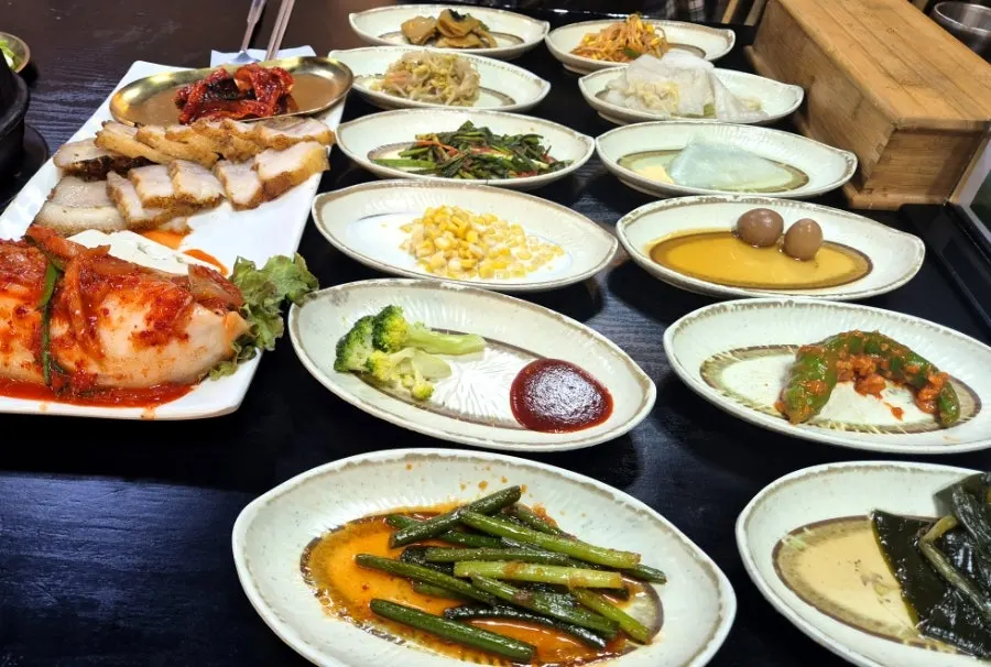 Table filled with side dishes, no empty space left
