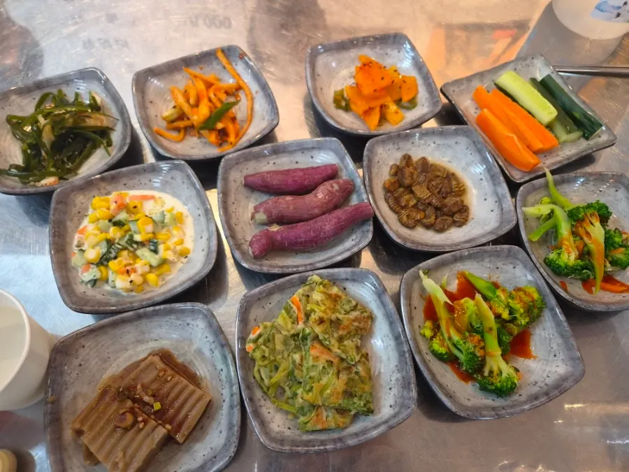 Full spread of banchan with omandi and namul