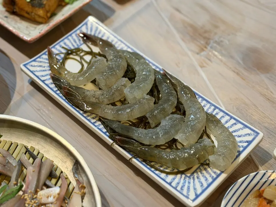 A plate of plump, springy raw shrimp sashimi