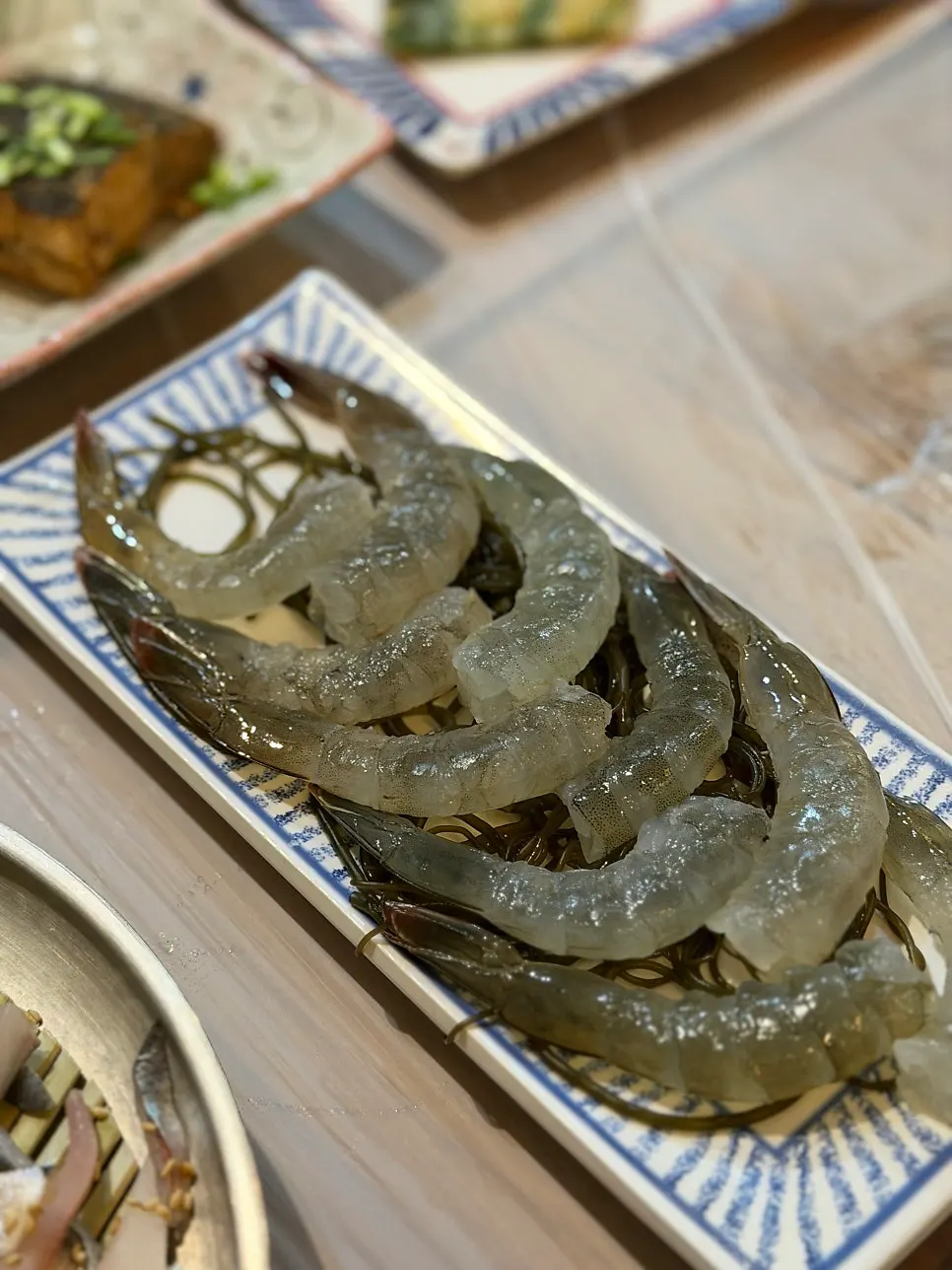 A piece of raw shrimp dipped in soy sauce