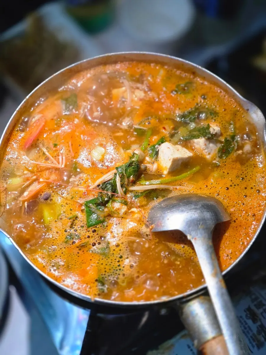 Spicy fish stew simmering in a pot