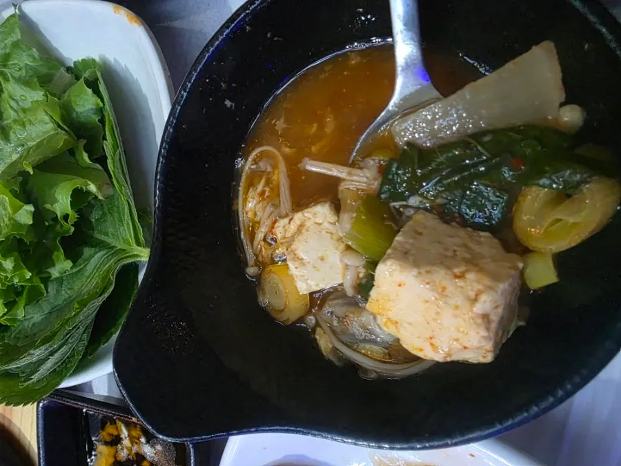 Spicy fish stew broth with fish and tofu