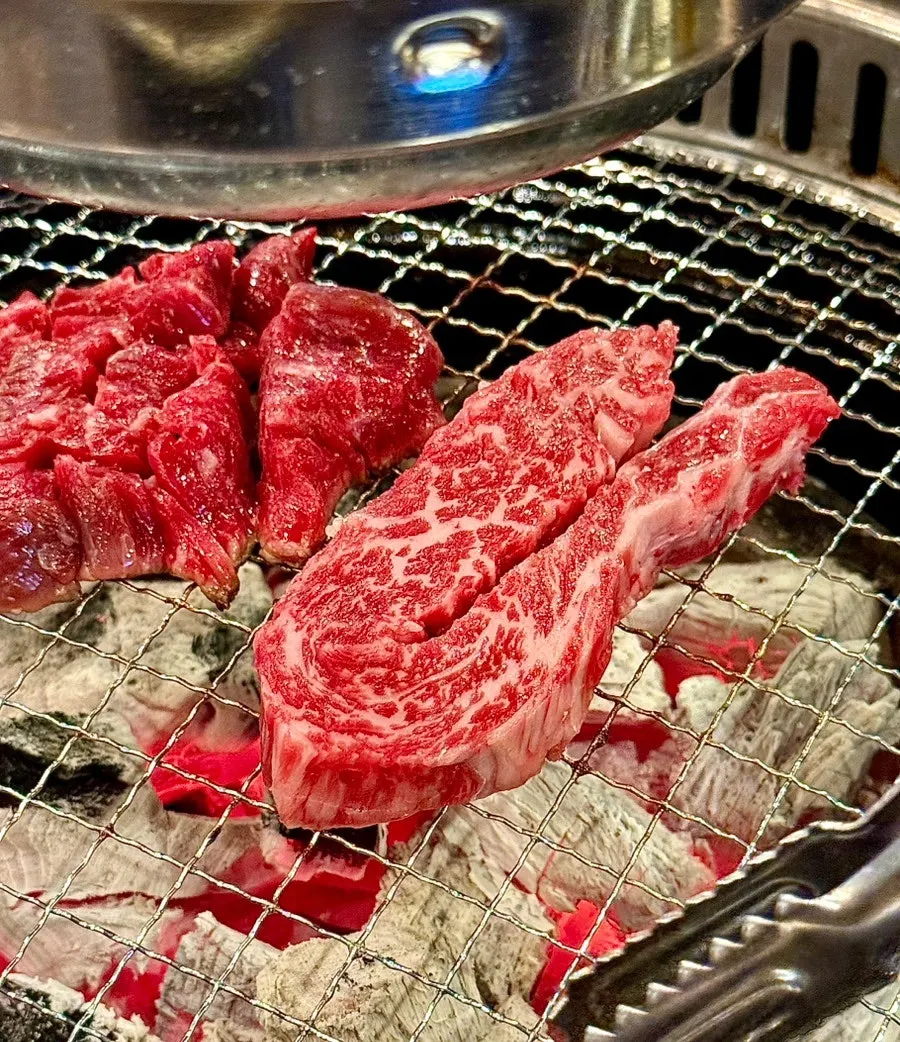 Grilled chuck flap tail hanwoo ready to be dipped in salt