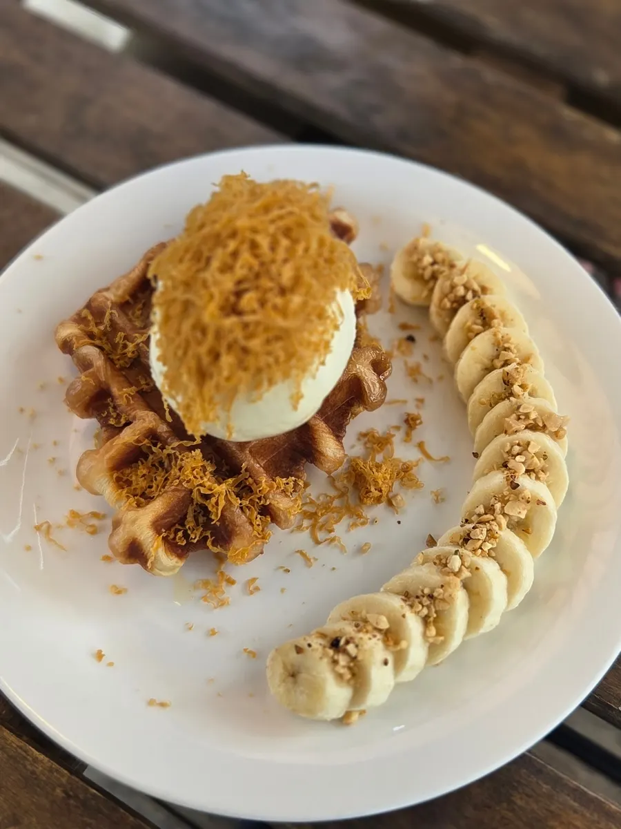 Eating Sisup's croffle topped with ice cream and banana
