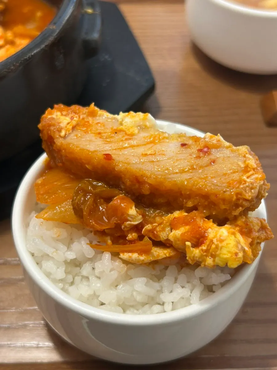 Spoonful of the sharp, spicy kimchi nabe broth