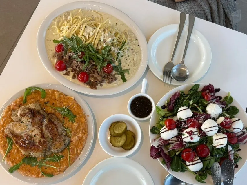A brunch spread of risotto, pasta and salad