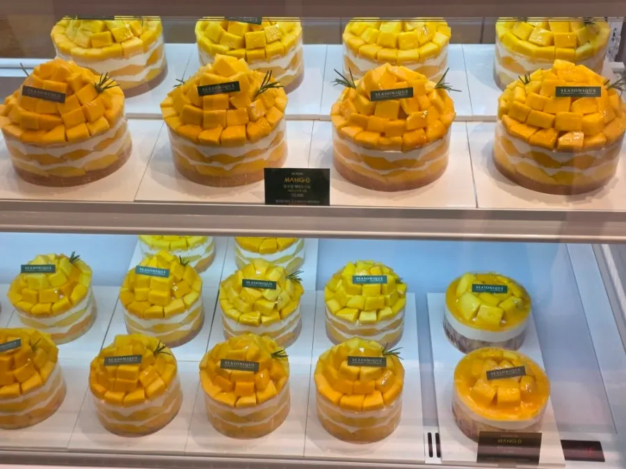 Mango Tower Cake topped with whole mangoes