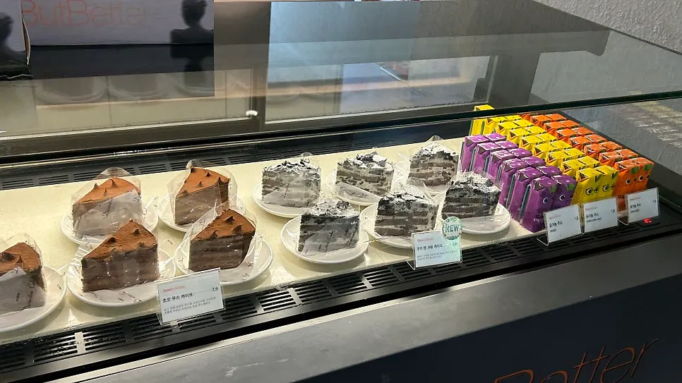 Dessert case with cakes and baby drinks