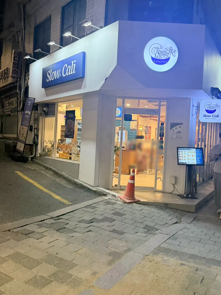 Blue signage exterior of Slow Cali Hongdae Entrance Station Branch
