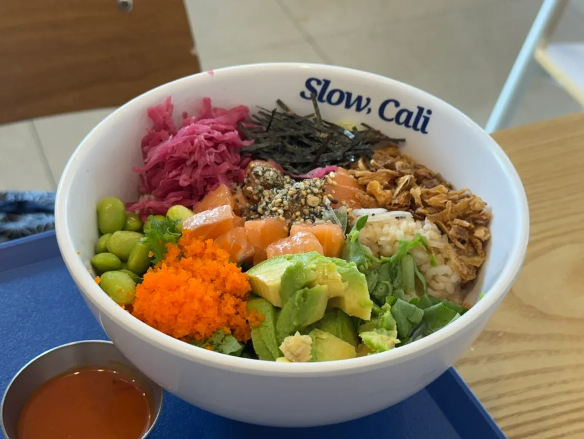 Slow Cali's menu board listing poke, bowls and salads
