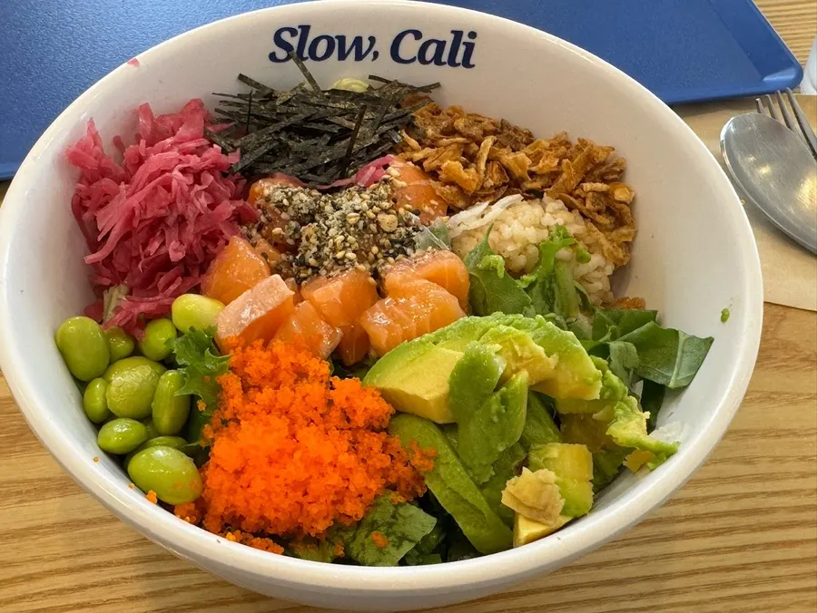 Salmon poke bowl with vegetables and brown rice