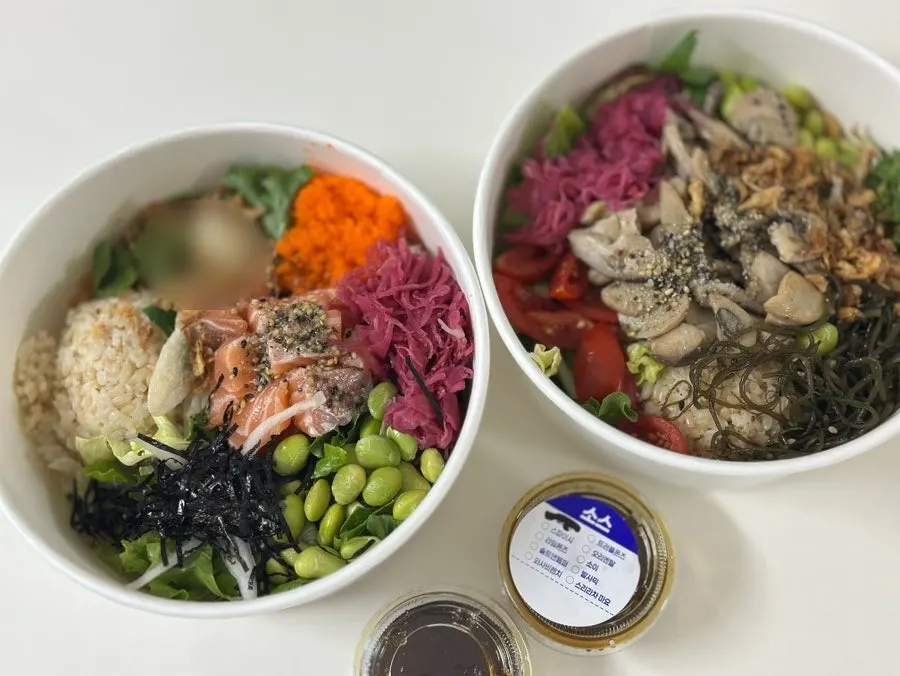 Salmon poke and truffle mushroom poke in takeout containers
