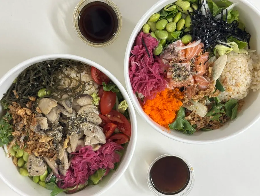 Two poke bowls filled with a variety of ingredients