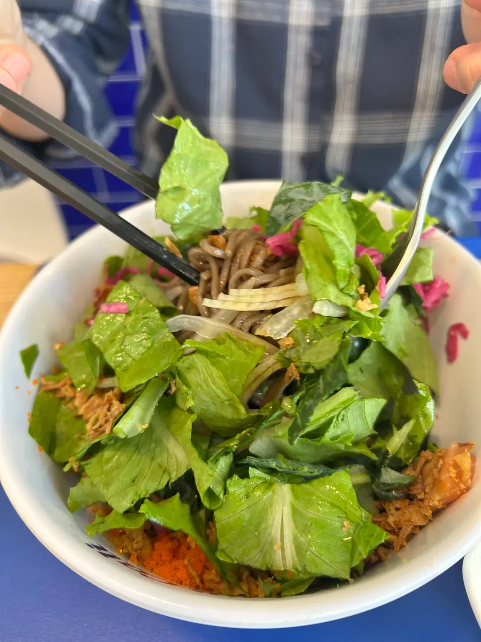 A spoonful of the mixed beef bowl