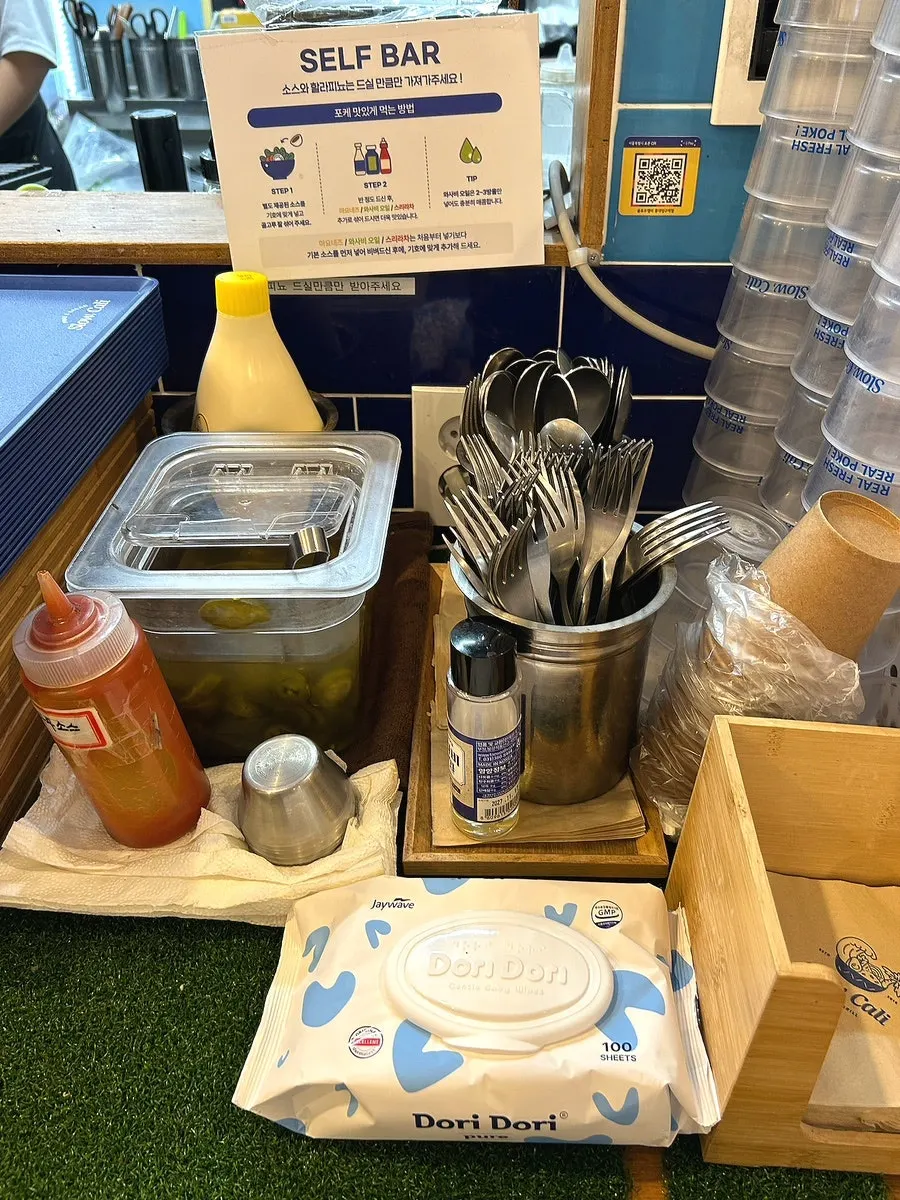 Self-serve bar with sriracha and jalapeños