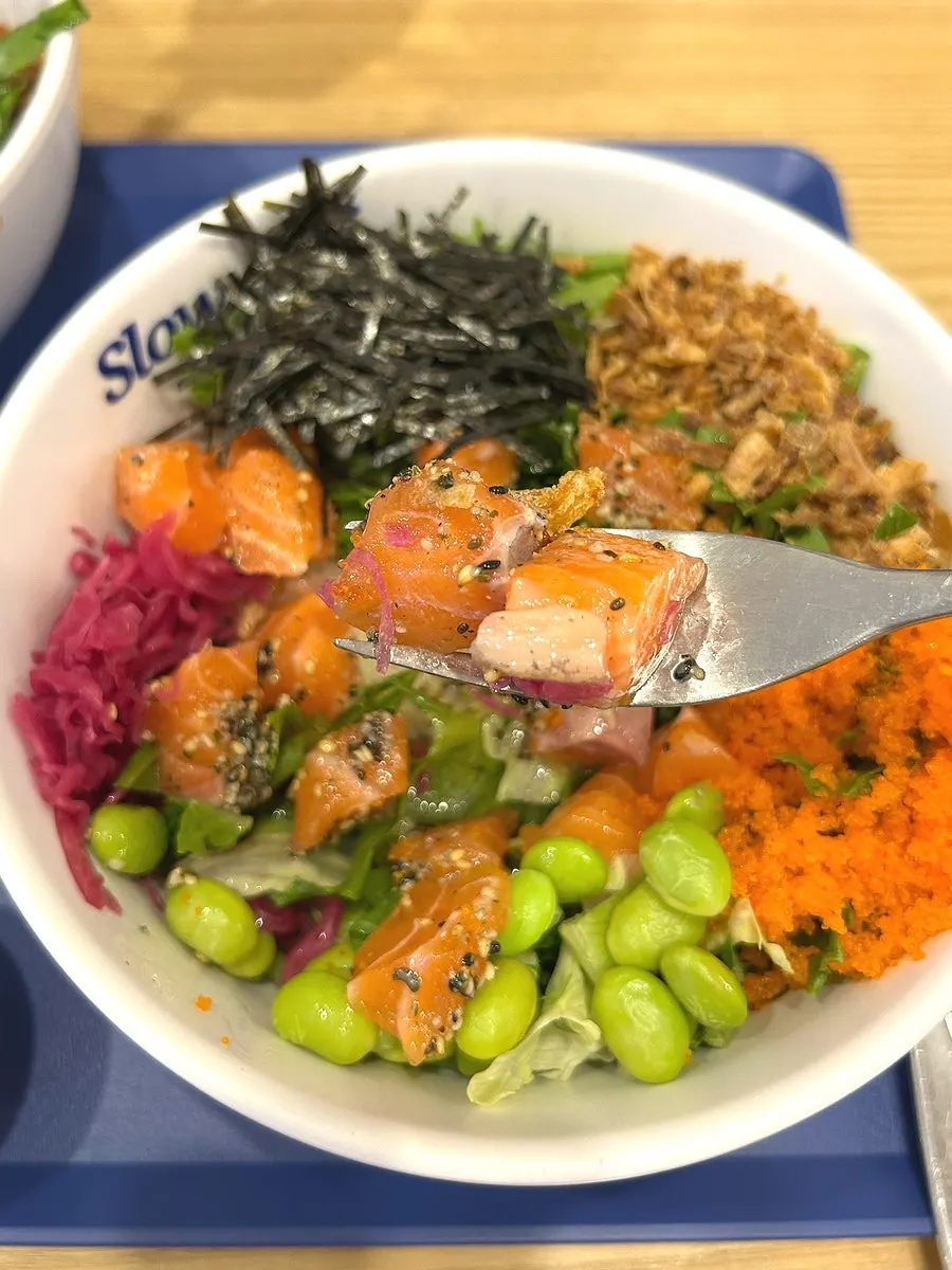 Salmon poke mixed with red cabbage and onion chips