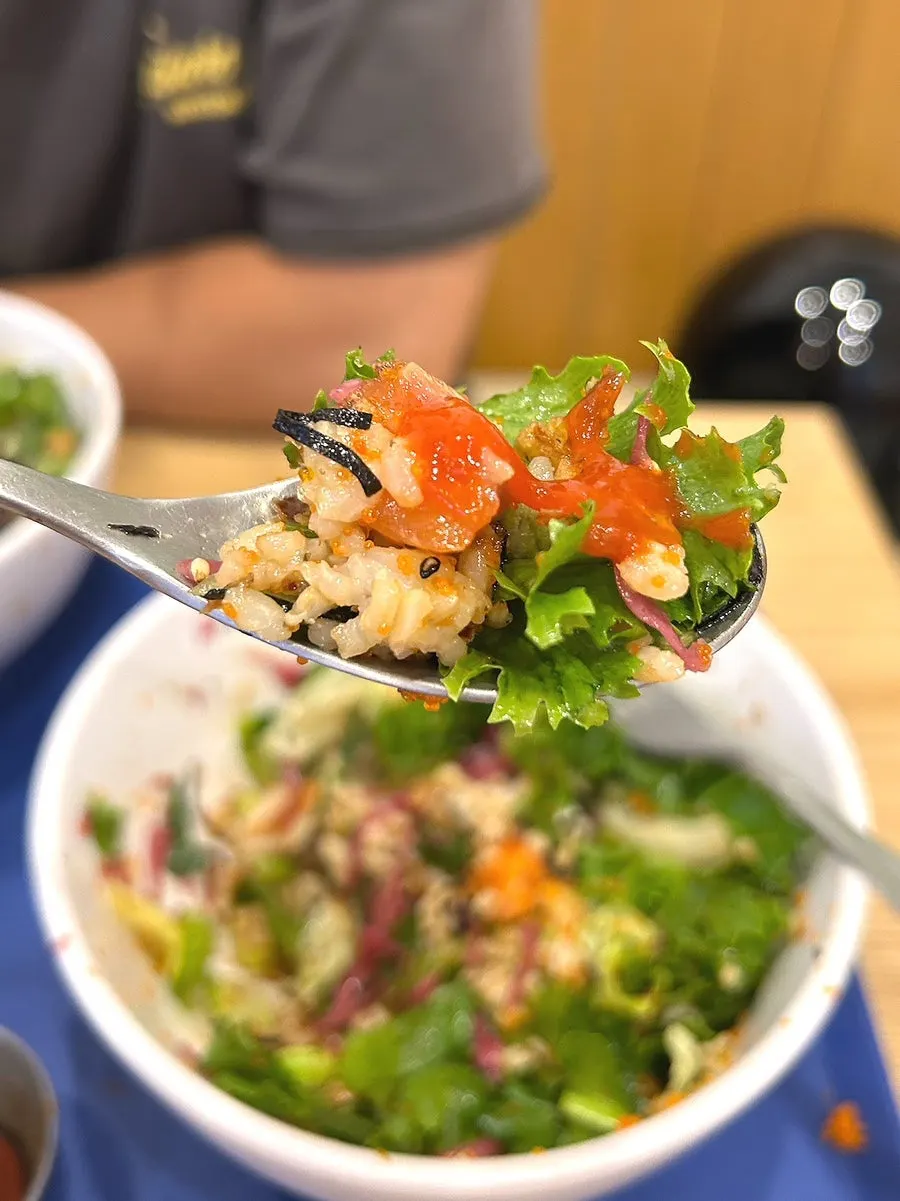 A bowl of salmon poke mixed spicy