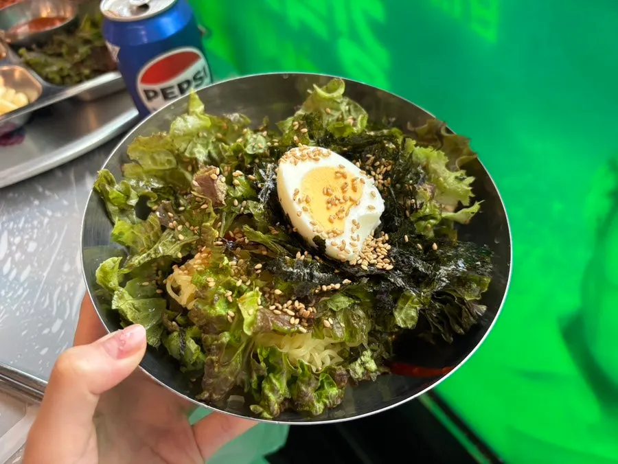 Smile Hall's bibimmyeon topped with egg and lettuce